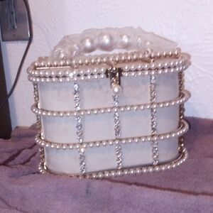 A party purse it is diamond and Pearl encrusted also suede easy to clean
